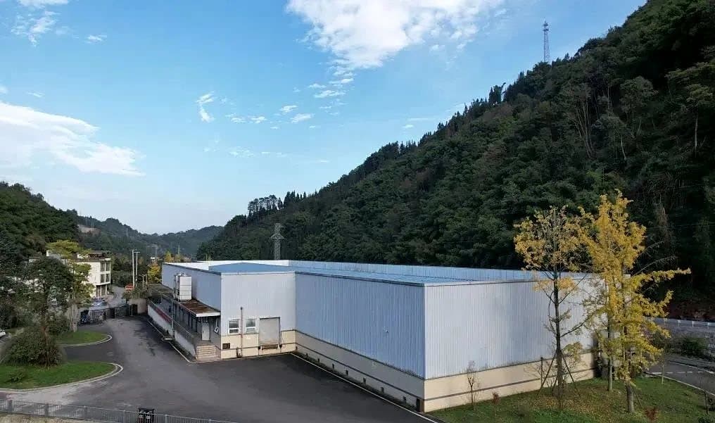 The farm’s processing center at the foot of a forested hill