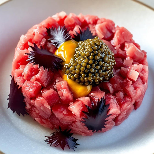 Steak tartare topped with black caviar, perfect for caviar blinis, osetra caviar, or a luxurious caviar gift set and sampler.